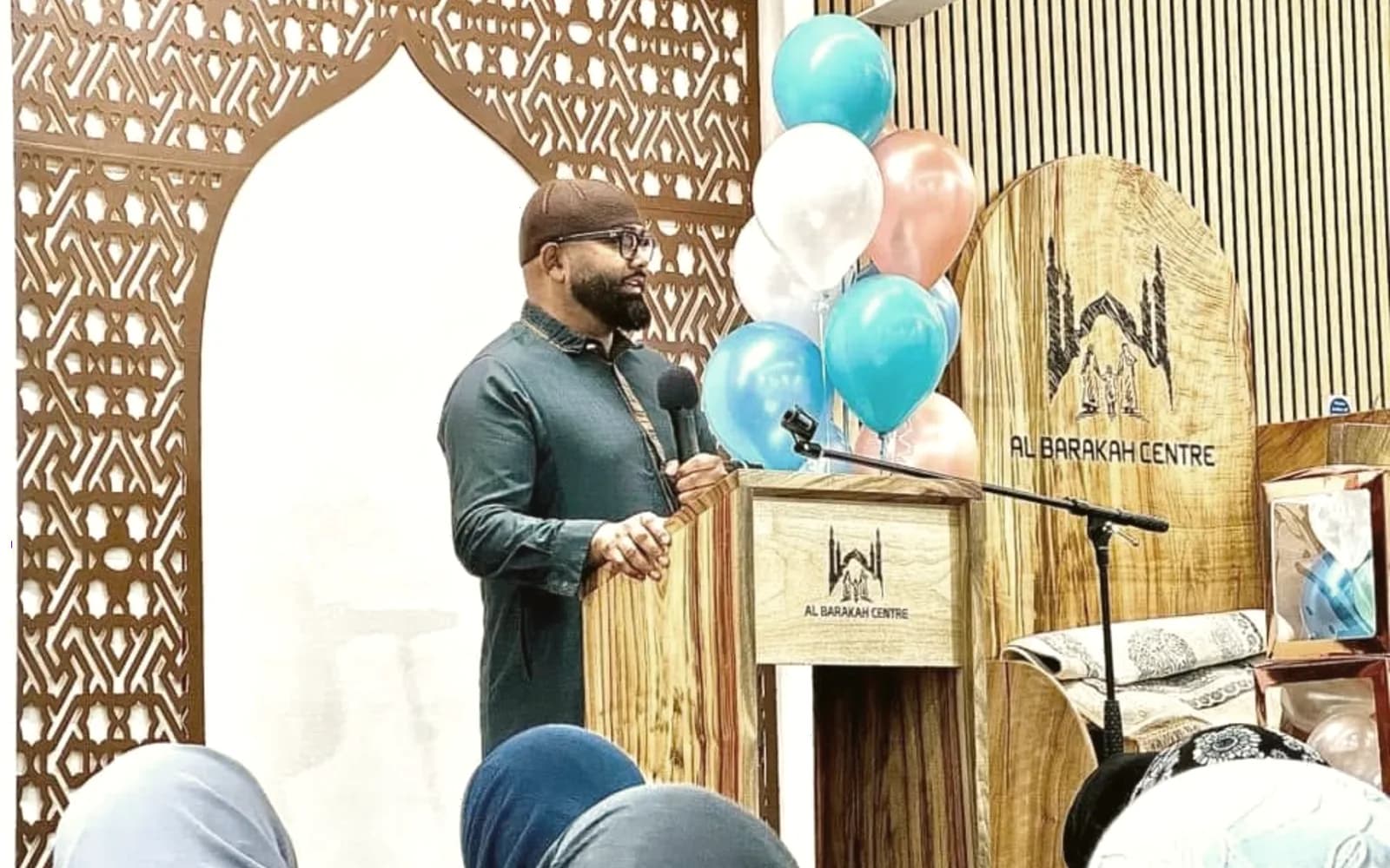 Arshad Khan speaking at a community centre event