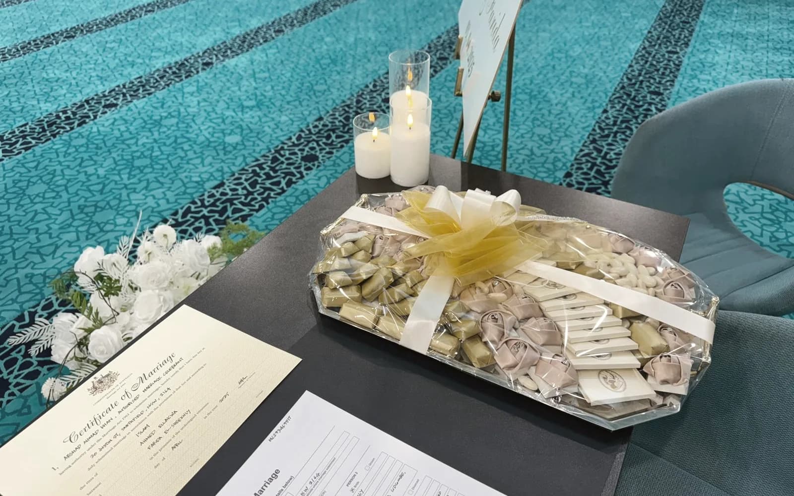 Signed certificate of marriage beside flowers and sweets